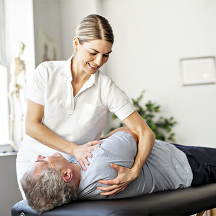 adjusting a patient's back in a clinic.