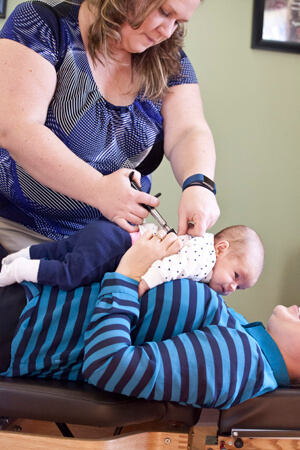 Dr Melissa adjusting an infant