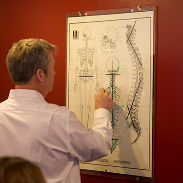 Dr. Cole looking at spine board