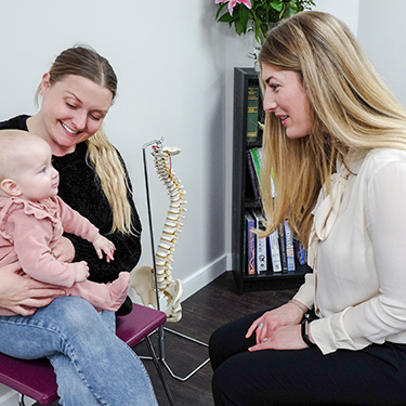 Dr. Heather talking with mom and baby