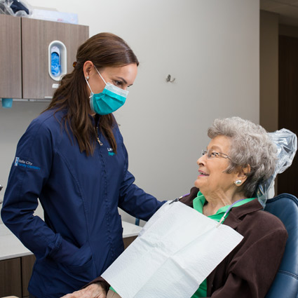 Dr. Eschendal and an older woman patient smiling at each other
