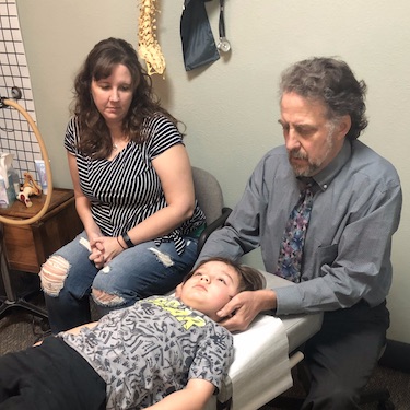 Dr. Bob Adjusting Young Patient