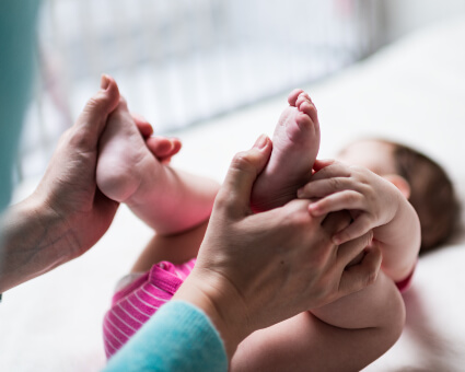 Infant receiving a chiropractic adjustment