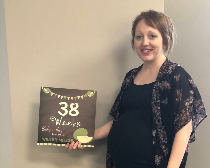 Pregnant patient holding card