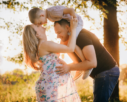 Pregnant mom with husband and young child
