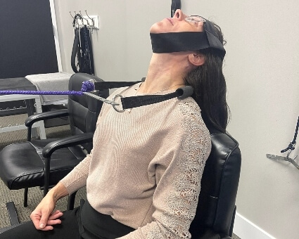 Woman receiving chiropractic neck treatment