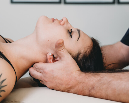 Female patient receiving cranial sacral therapy treatment