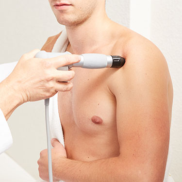 laser therapy being applied on a patient's shoulder