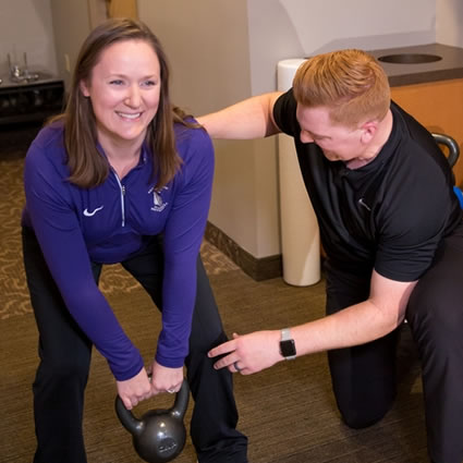 Female lifting kettlebell