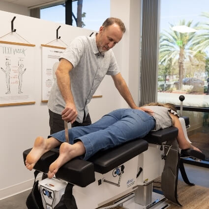 chiropractor adjusting patients legs