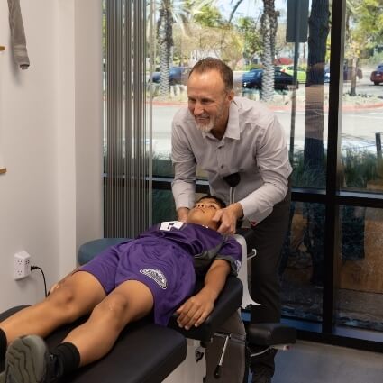 chiropractor adjusting childs neck