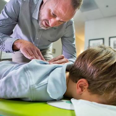 Dr. Cameron adjusting boy