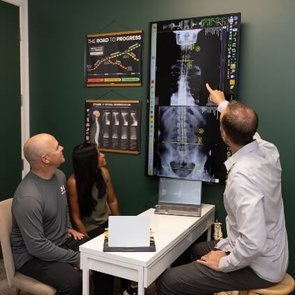 our chiropractor pointing at an xray