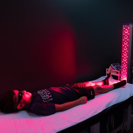 child laying on our red light therapy table