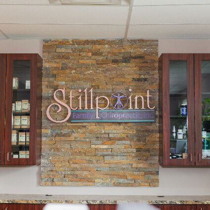 Stillpoint Family Chiropractic interior logo on wall