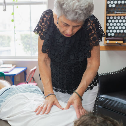 Fishers Chiropractor Dr. Mary Grace adjusting patient's back