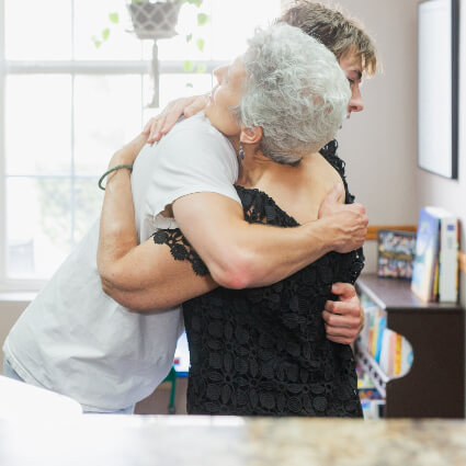 Dr. Mary Grace hugging patient