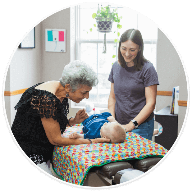 Fishers Chiropractor Dr. Pennella checking toddler on adjusting table