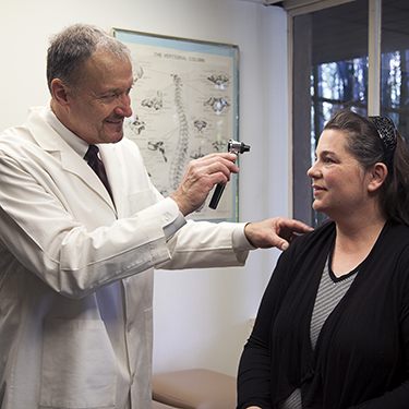 doctor examining female patient