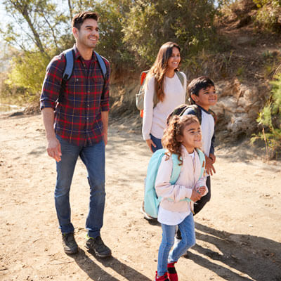 happy family hiking on a trail