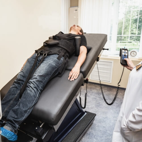 Spinal traction treatment used for male patient