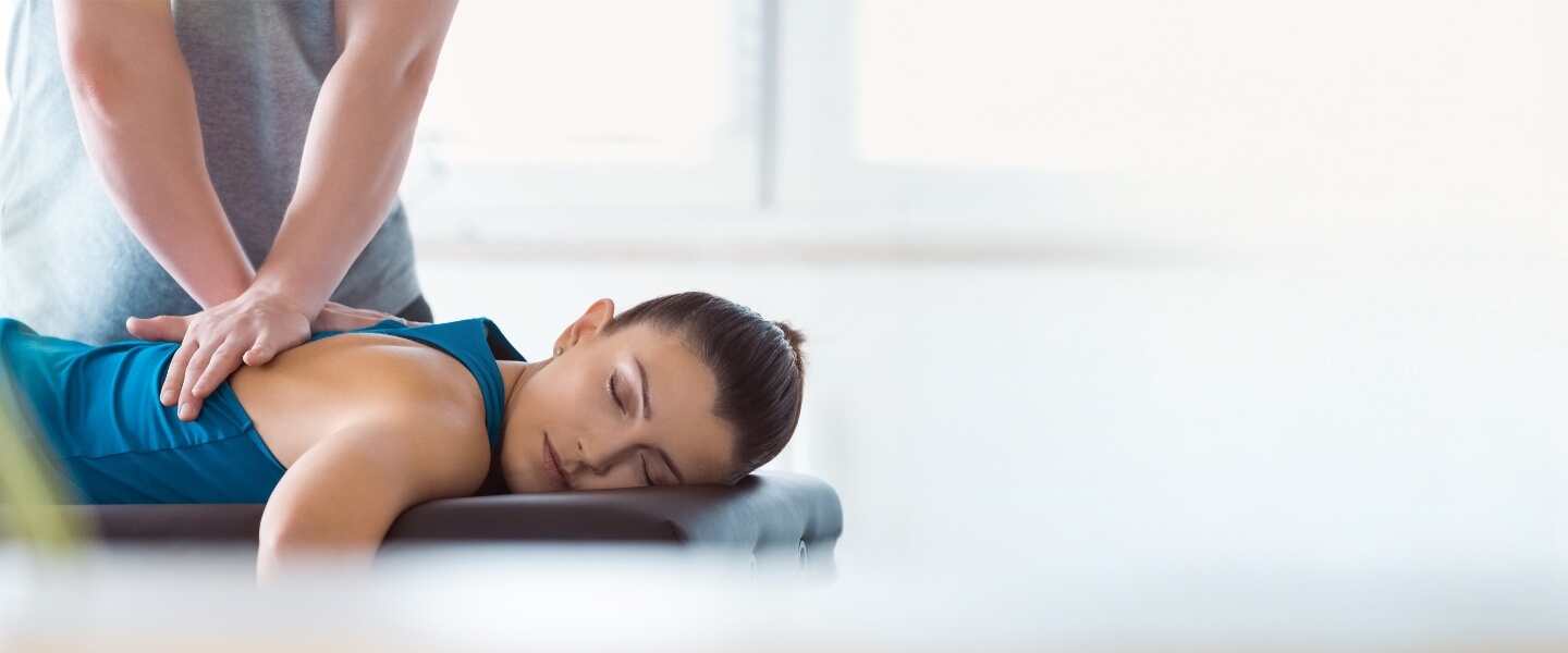 Female patient treated with chiropractic back adjustment