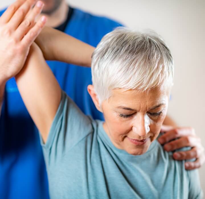 Female patient getting her arm adjusted