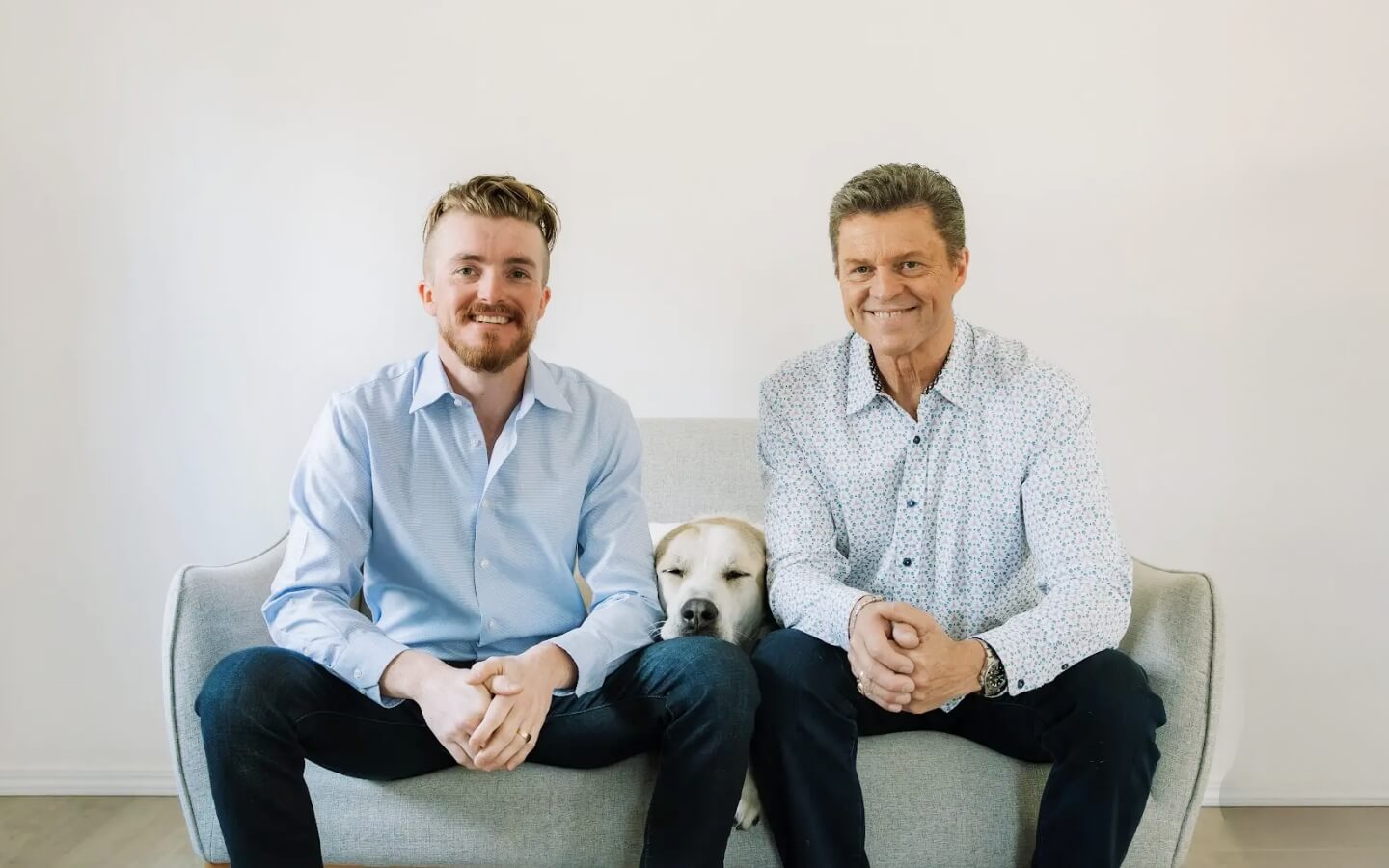 Silverdale chiropractors Dr. Stephen Clark and Dr. Drew Clark sitting on couch with a dog