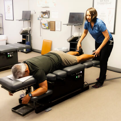 Dr. Laura holding man's feet