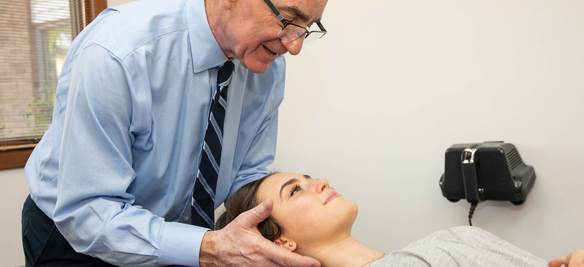 Dr Freedman adjusting patients neck
