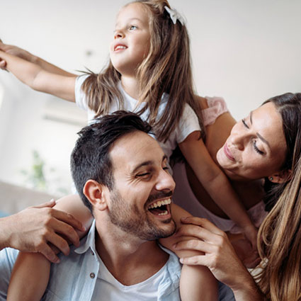 family of 3 smiling