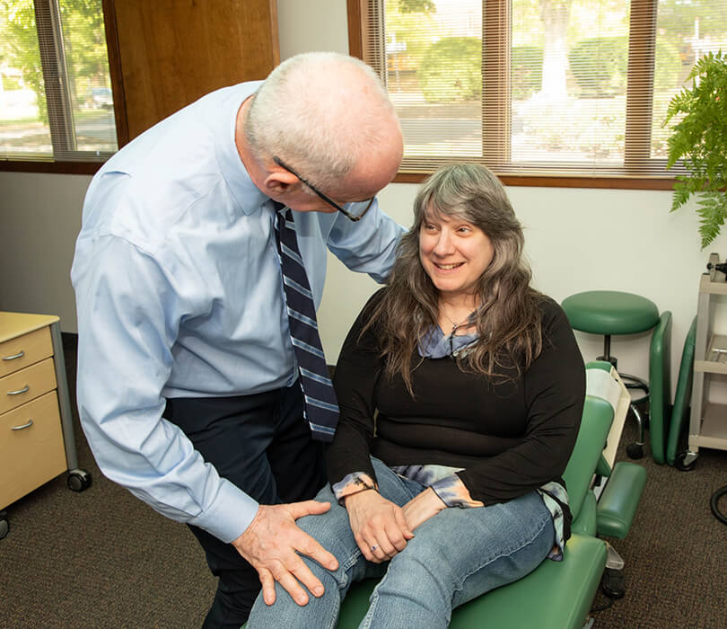 Dr. Freedman talking to patient in chair