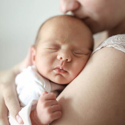 newborn-resting-on-mothers-shoulder-sq