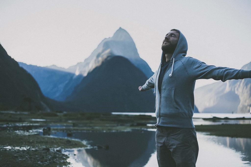 Man standing beside a lake in the country