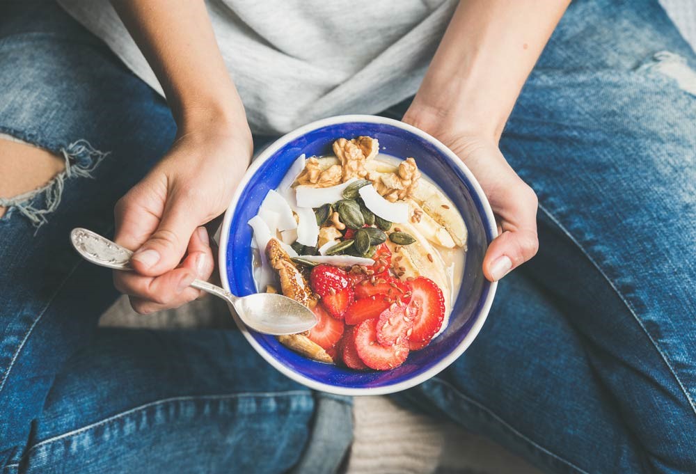 man holding a plate of healthy meal