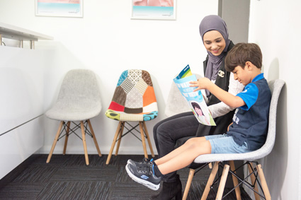 Doctor sitting with child in waiting room