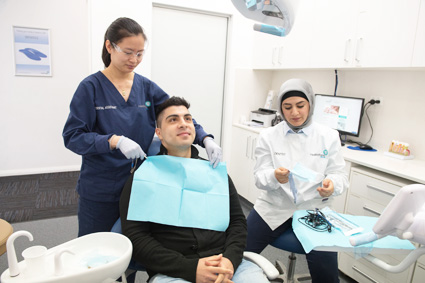 Dental assistant preparing patient for treatment