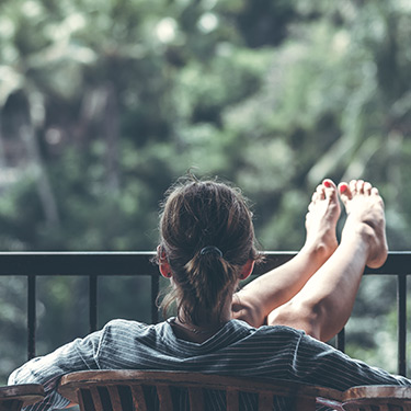 woman relaxing on a balcony