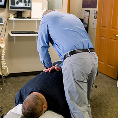doctor doing a chiropractic adjustment on a patient