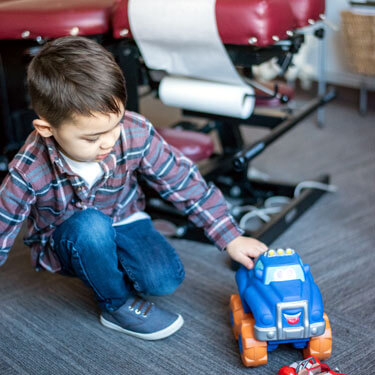 Child playing with toy truck