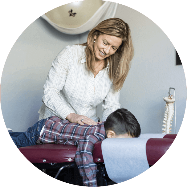 chiropractor adjusting pediatric patient