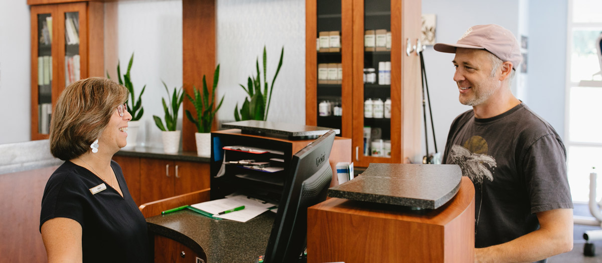 Receptionist greeting a patient.