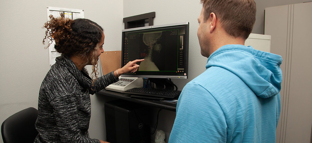 practitioner reviewing xrays with a patient
