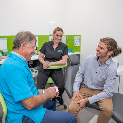 Dentist and Assistant with Patient