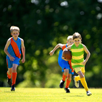 Girls and boys playing rugby