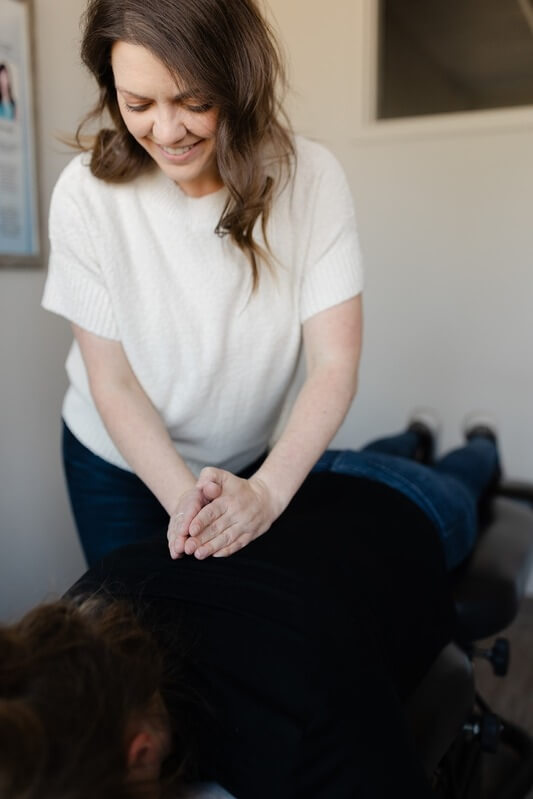 Chiropractor adjusting patient's back