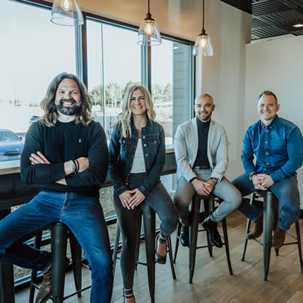 team sitting on stools