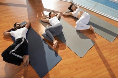 3 people lying on yoga mats