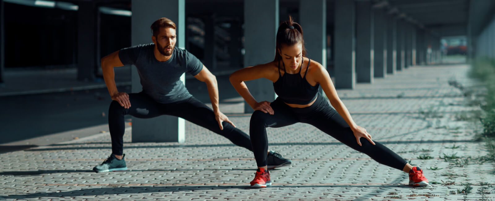 Man and woman training outdoors