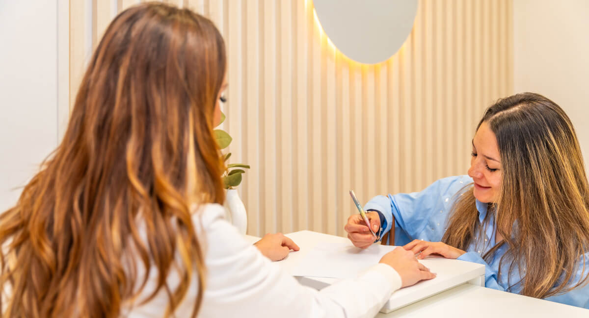 Female patient filling in paperwork